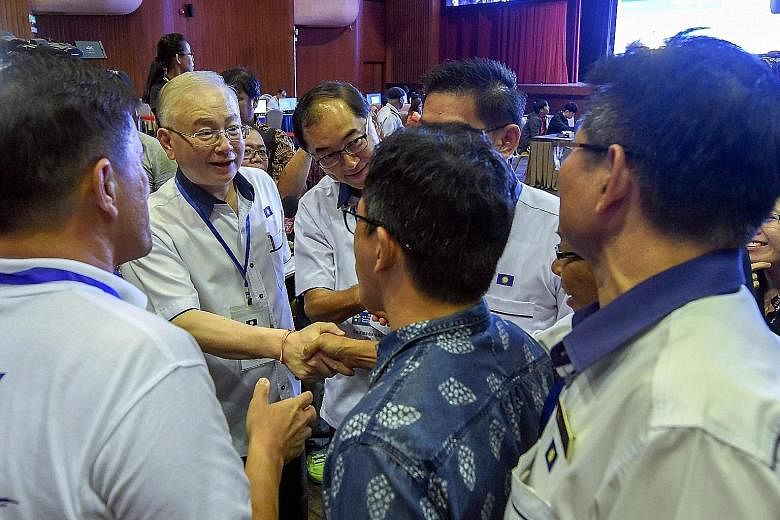 Malaysian Chinese Association president Wee Ka Siong shaking hands with party supporters after the annual assembly on Sunday. Next to him is his deputy Mah Hang Soon. Datuk Seri Wee has called for Barisan Nasional, the former ruling coalition of whic