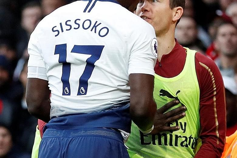 Tottenham's Moussa Sissoko clashing with Arsenal's Stephan Lichtsteiner following Eric Dier's overexuberant celebrations after scoring Spurs' first goal. Harry Kane netted the other in the 4-2 loss, while Pierre-Emerick Aubameyang (two), Alexandre La
