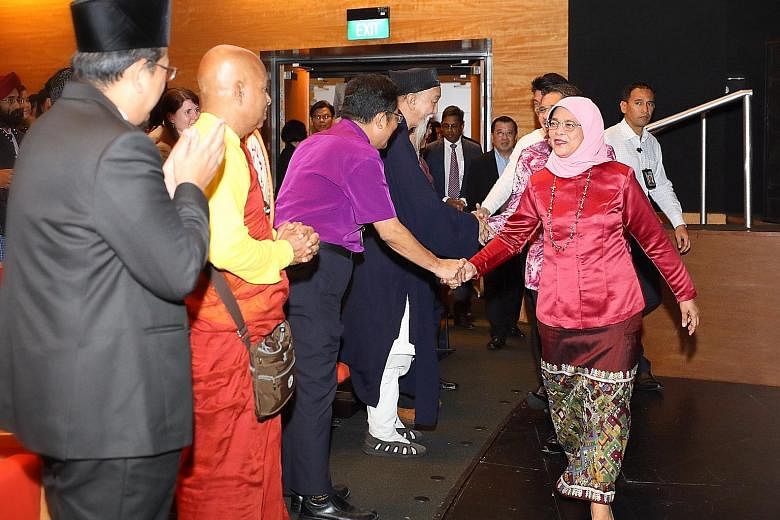 President Halimah Yacob meeting interfaith leaders at the launch yesterday of Faithfully Asean, an inaugural regional interfaith exchange programme.