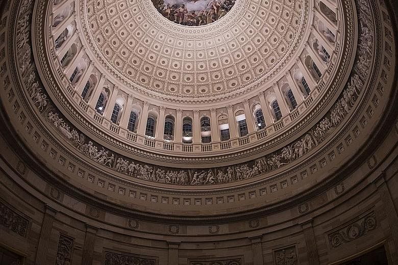 Members of the public paying their respects at the flag-draped casket of former US president George H.W. Bush in the Rotunda of the US Capitol in Washington on Monday.