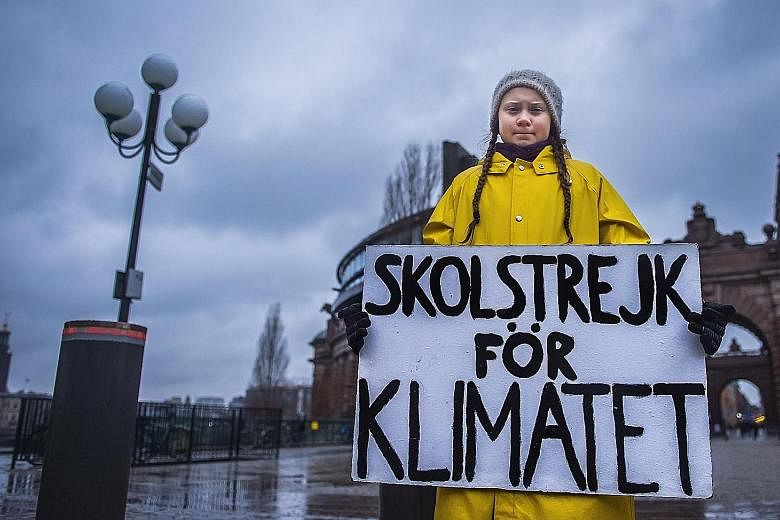 Student Greta Thunberg holding a placard reading "School strike for the climate", during a protest against climate change outside the Swedish Parliament in Stockholm last week. The 15-year-old Swede has inspired a global movement of children skipping
