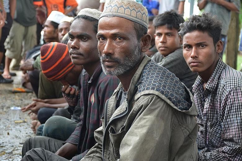 Some of the migrants, believed to be Rohingya, in Aceh's Idi Rayeuk district yesterday. It is not known where the group set off from.