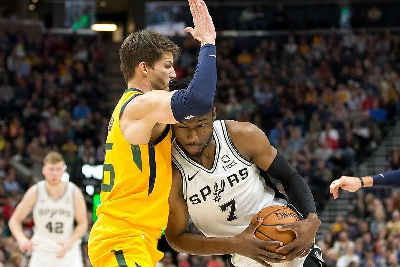 Utah Jazz guard Kyle Korver trying to block San Antonio Spurs forward Chimezie Metu from advancing during the second half of the National Basketball Association game at Vivint Smart Home Arena on Tuesday. The Jazz won 139-105.