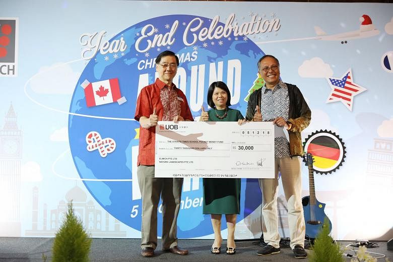 Mr Alan Lee (left) and Mr Michael Teh from Elmich presented a cheque for their donation to Ms Tan Bee Heong, general manager of The Straits Times School Pocket Money Fund, yesterday.