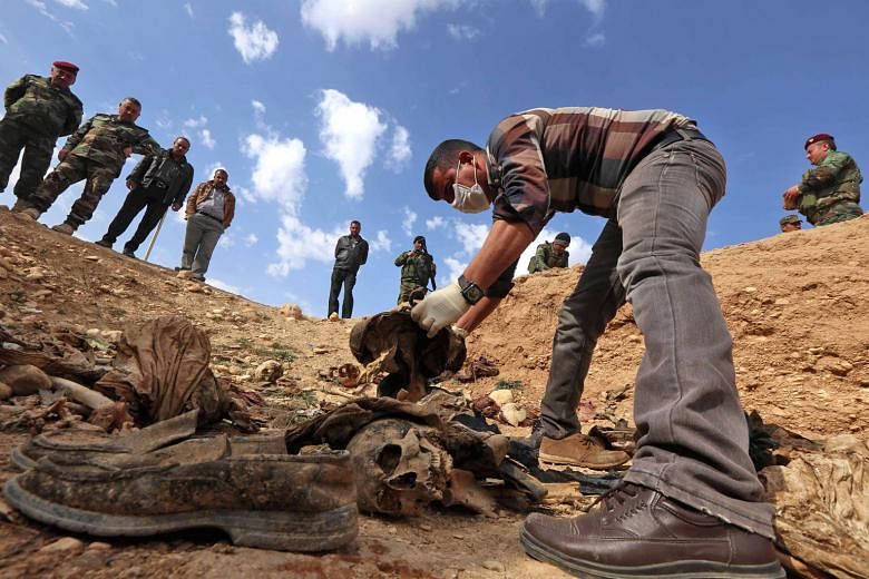 Members of the Yazidi minority in February 2015 searching for clues that might lead them to missing relatives. More than 200 mass graves containing up to 12,000 bodies have been recently discovered in Iraq, providing evidence of war crimes by ISIS.