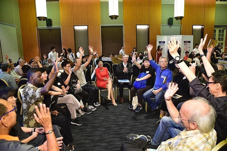Second Minister for Finance Indranee Rajah (in red) and Reach chairman Sam Tan (centre) interacting with participants at the Pre-Budget 2019 Dialogue at the Asian Civilisations Museum yesterday. Innovation, and how the Government can give this a boos