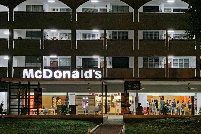 People queueing at the McDonald's outlet in Hougang Avenue 8 around 3.30am yesterday for limited-edition food holders (far right) featuring the Sanrio character My Melody. A McDonald's spokesman said the holders were sold out across Singapore by 11.3