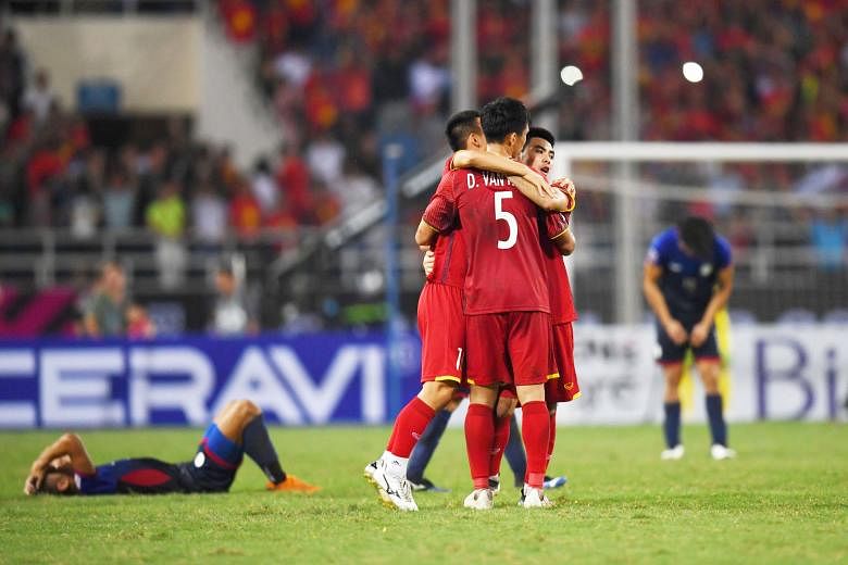 Vietnam's players celebrating at the end of their 2-1 AFF Suzuki Cup semi-final second-leg win over the Philippines yesterday at the My Dinh Stadium in Hanoi, for an aggregate scoreline of 4-2. Vietnam face Malaysia in the final over two legs on Tues