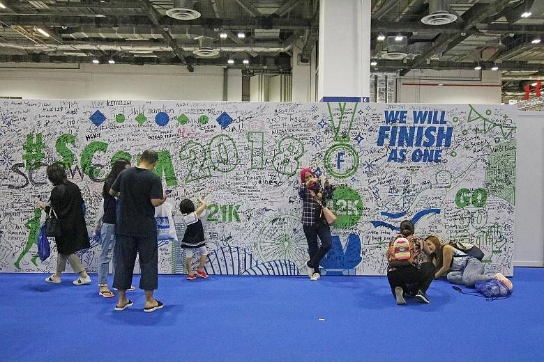 A wall for SCSM participants to write words of encouragement, aspirations and cheers at the . race pack collection in Marina Bay Sands Expo and Convention Centre yesterday.