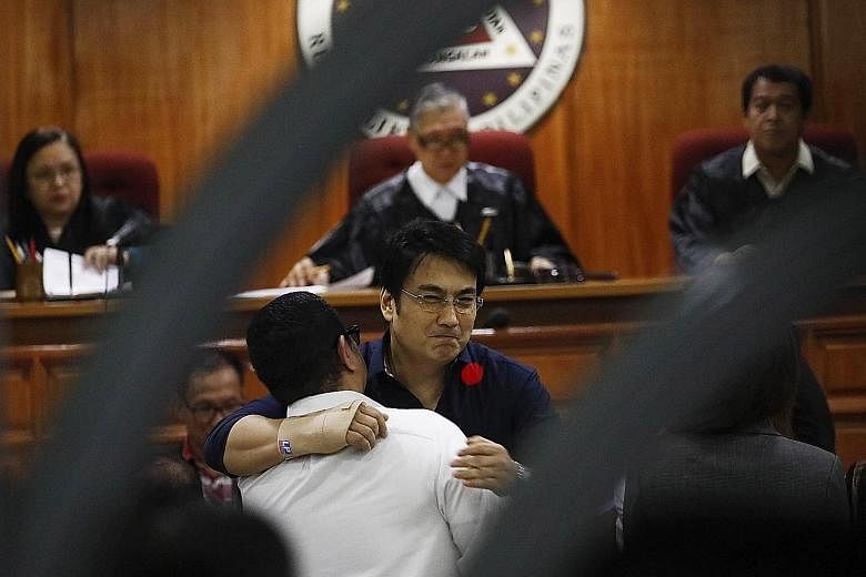 Above: Political fixer Janet Napoles, the purported mastermind behind the "pork barrel" scandal, was found guilty of plunder and sentenced to 40 years in jail. Right: Popular actor and former senator Ramon Revilla Jr (right) embracing his lawyer at t