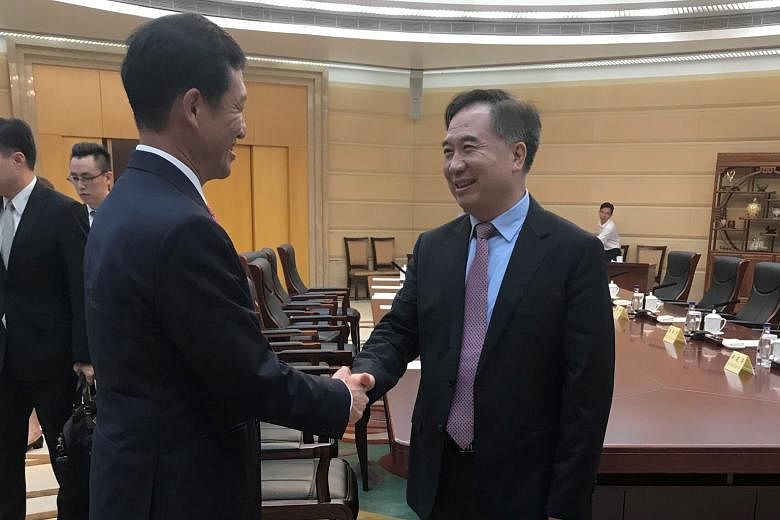 Education Minister Ong Ye Kung (left) calling on Guangdong party boss Li Xi yesterday. Mr Ong is visiting southern Guangdong, where he tested the latest transport links in the Greater Bay Area. The area is positioned as part of a strategic plan for C