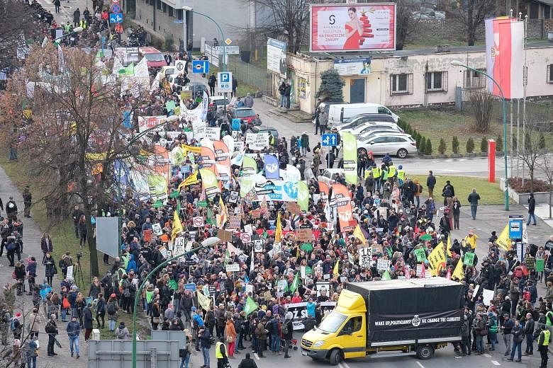 Participants of a march in Katowice, Poland, yesterday to call for more action to combat global warming. Singapore's Minister for the Environment and Water Resources Masagos Zulkifli is due to arrive in Katowice tomorrow, ahead of the high-level segm