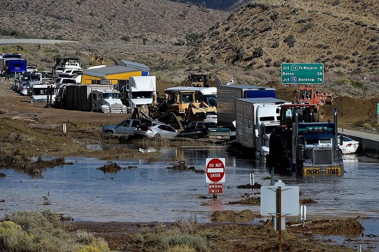 Vehicles stuck on a road, trapped by a mudslide in California. Climate changes pose challenges to investors, the writer says.