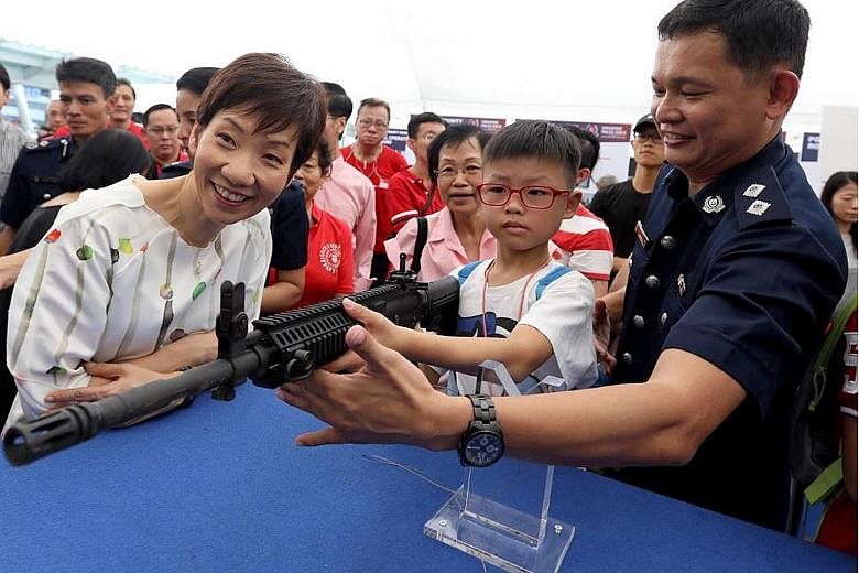 Minister for Culture, Community and Youth Grace Fu visiting a police community roadshow in Jurong East yesterday. She said the Police Coast Guard has been made even busier patrolling Singapore's waters recently because Malaysian vessels have started 