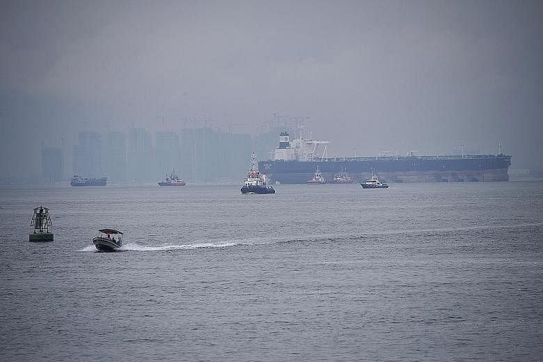 A Singapore Police Coast Guard vessel (far right) patrolling Singapore's territorial waters last Thursday.