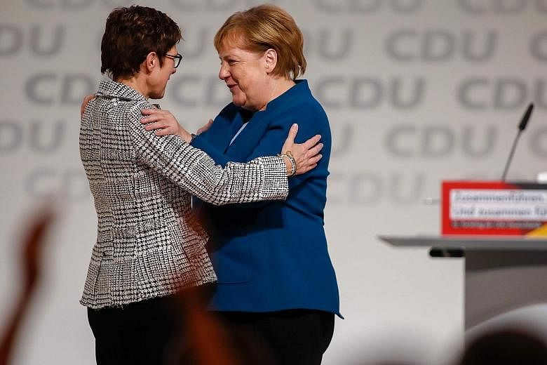 German Chancellor Angela Merkel congratulating her protege, Mrs Annegret Kramp-Karrenbauer, after the latter won a party vote to succeed her as leader of the conservative Christian Democratic Union last Friday. AKK - as she is popularly known by her 