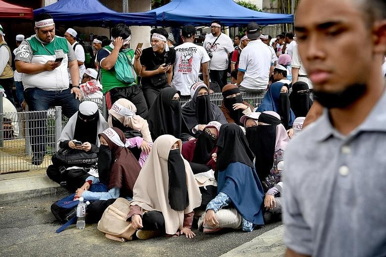 Left and top: Protesters gathering at Dataran Merdeka in Kuala Lumpur yesterday to take a stand against the United Nations' International Convention on the Elimination of All Forms of Racial Discrimination. Above: Former prime minister Najib Razak an