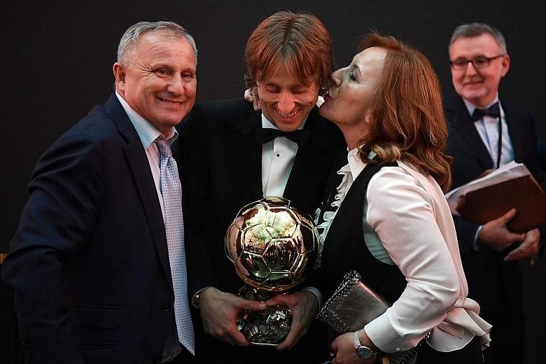 Real Madrid's Croatian midfielder Luka Modric with his parents after winning the Ballon d'Or award at the Grand Palais in Paris on Monday, breaking the 10-year duopoly of Cristiano Ronaldo and Lionel Messi. Dozens of Croats now play in the top footba