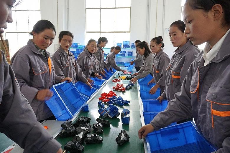 Students at Lhasa No.2 Secondary Vocational and Technical School in Lhasa City (above) learn basic vocational skills like assembly-line work at a mock factory. Their courses are fully subsidised by the local government.