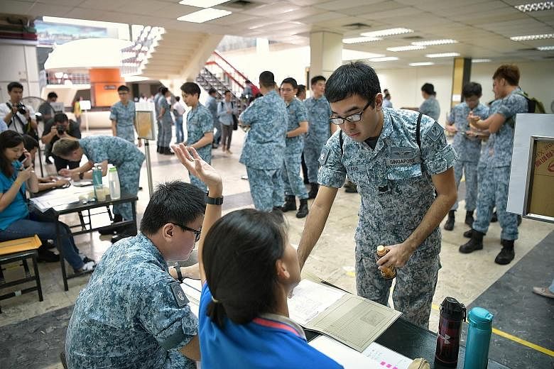 RSAF servicemen reporting to Paya Lebar Air Base during the mobilisation exercise yesterday. More than 90 per cent of the servicemen reported to their air bases within a few hours, Defence Minister Ng Eng Hen said on Facebook, calling it a "successfu