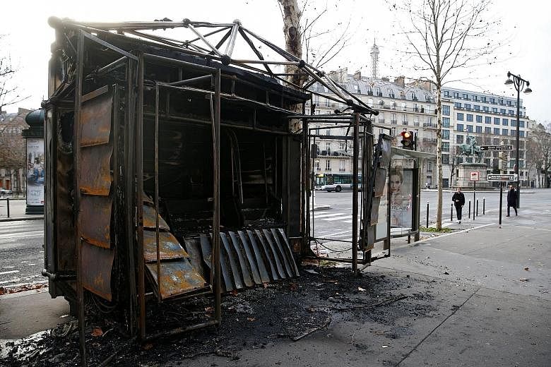Paris bore the brunt of the "yellow vest" demonstrations last Saturday, the fourth weekend of nationwide protests in France. Vehicles (above) and a news stand (below) were burnt.