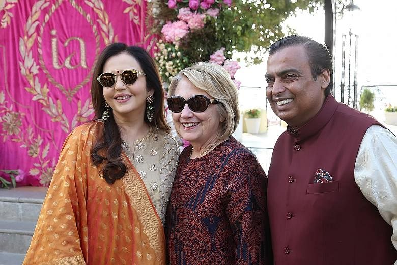Mrs Hillary Clinton (above centre) received by Mr Mukesh Ambani and his wife Nita in Udaipur last Saturday. Singer Beyonce (left) was flown in to perform at the pre-wedding celebrations of Mr Ambani's daughter Isha.