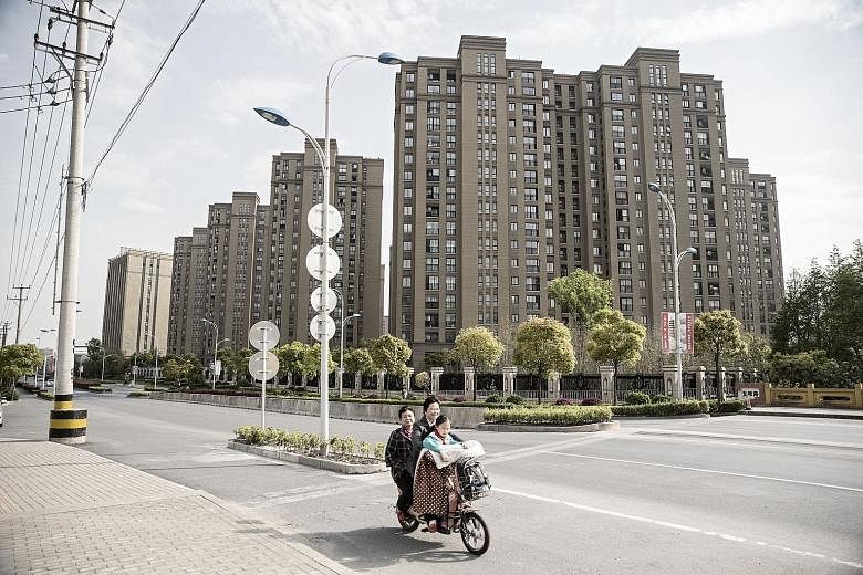 A high-rise residential development in Shanghai. Real estate underpins China's US$1.4 trillion (S$1.9 trillion) non-performing loan market, accounting for up to 80 per cent of debt in portfolios sold, said PricewaterhouseCoopers.