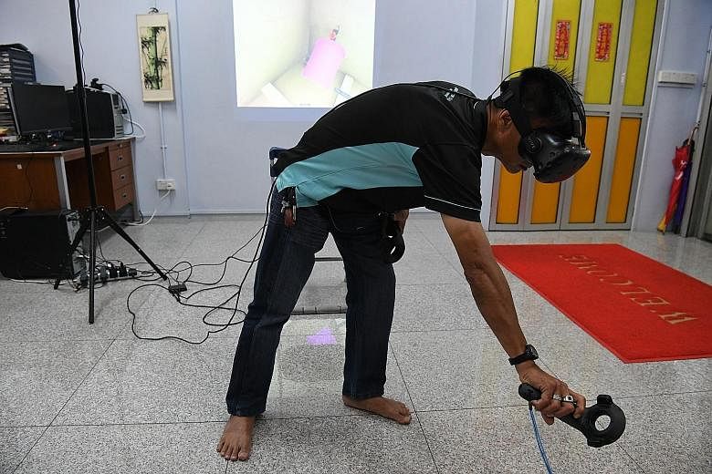 Mr Tan donning a pair of virtual reality goggles as he polishes his skills. Training has allowed him to climb the ranks at local firm Ministry of Clean, and he is now a supervisor after eight years on the job. Singapore Polytechnic students Gary Seah