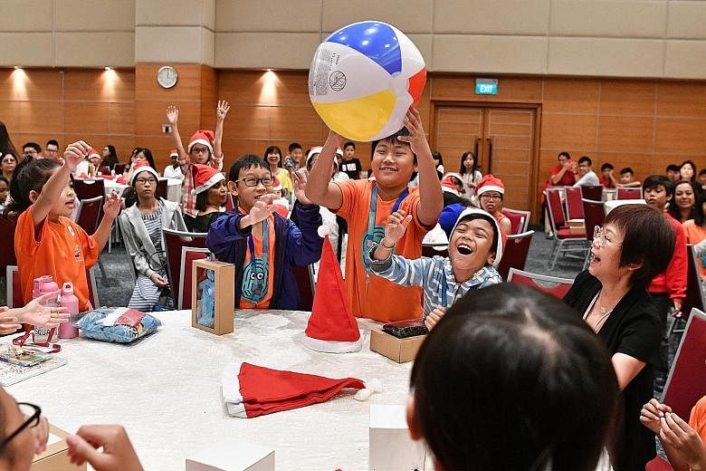 Reuben Tan, 10, from Care Community Services Society enjoying a game at a lunch party yesterday hosted by Singapore Press Holdings (SPH). He was among 160 beneficiaries from charitable organisations and their caregivers who were treated to games and 