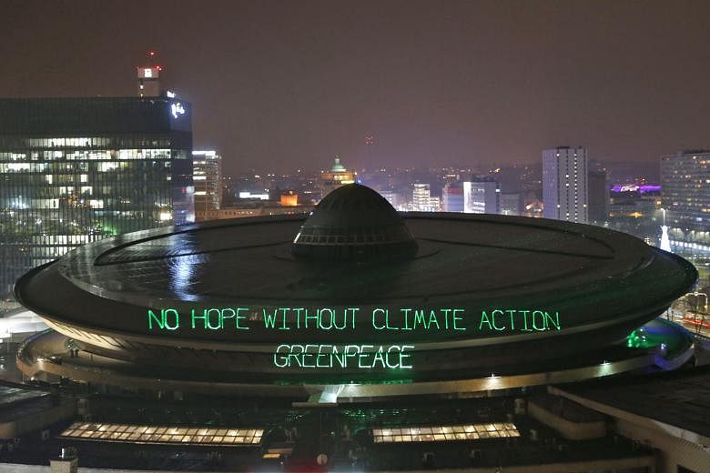 Greenpeace activists illuminating the Spodek arena during the COP24 summit on Sunday.
