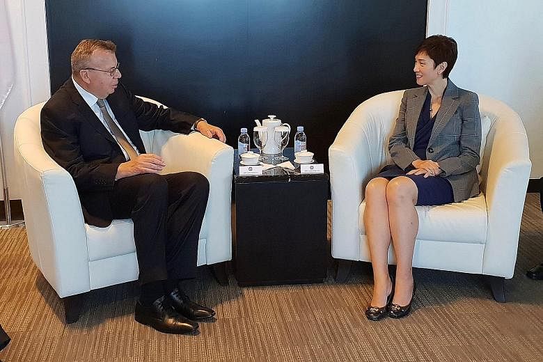 Mr Yury Fedotov, executive director of the United Nations Office on Drugs and Crime, with Minister for Manpower Josephine Teo on Monday.