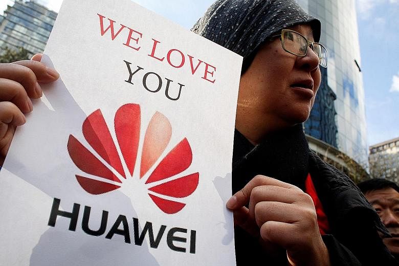 A Huawei supporter outside the British Columbia Supreme Court on Monday where Ms Meng Wanzhou's bail hearing was held. Ms Wang's arrest has stoked public anger in China.