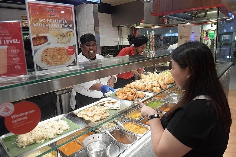 Above: Prata Wala's outlet at Nex shopping mall. Left: Dishes with wholegrains such as prata, naan and biryani rice are available at Prata Wala, the first prata restaurant chain to come on board the HPB's Healthier Dining Programme.