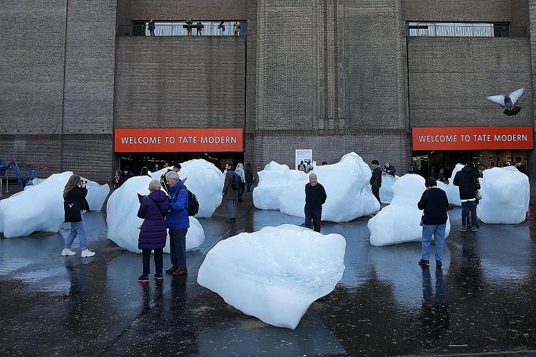 Blocks of ice from an exhibit entitled Ice Watch by Icelandic-Danish artist Olafur Eliasson and leading Greenlandic geologist Minik Rosing melting on Tuesday outside Tate Modern in central London. The gradually thawing ice is meant to demonstrate to 