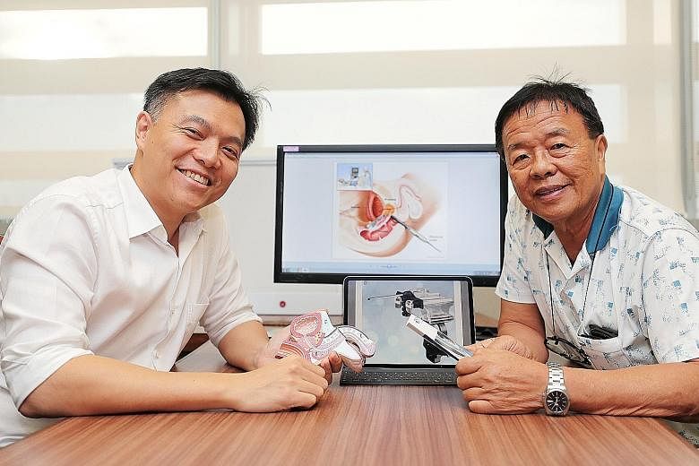 Dr Lincoln Tan (left), NUH's director of urologic oncology, with Mr Tan Ai Poh, a patient who had the transperineal prostate biopsy carried out last month with local anaesthesia and has been given the all-clear.