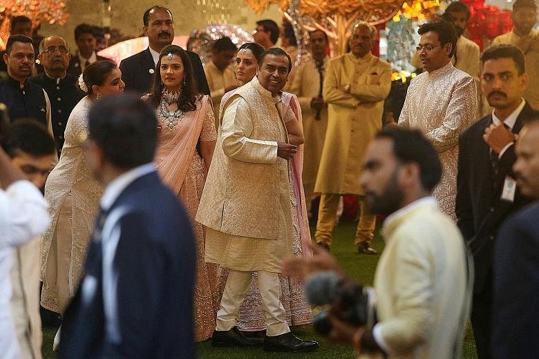 Above: The wedding procession outside the Ambanis' 27-storey home. Ms Isha Ambani married Mr Anand Piramal, the scion of another wealthy family. Above: Mr Mukesh Ambani, chairman of oil-to-telecoms conglomerate Reliance Industries, at his only daught