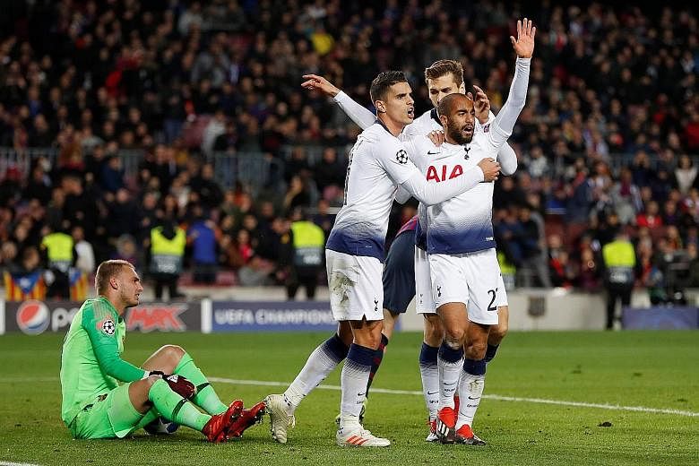 Tottenham's Lucas Moura (front) celebrates with teammates Erik Lamela and Fernando Llorente after scoring the vital equaliser against Barcelona at the Nou Camp on Tuesday. The 1-1 result ensured that Spurs are through to the last 16 of the Champions 