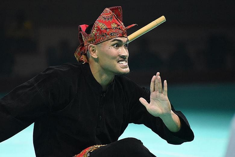 Iqbal Abdul Rahman showing his skills in the men's artistic single event at the 18th World Pencak Silat Championship yesterday. The 25-year-old Singaporean clinched his first world title in five attempts.