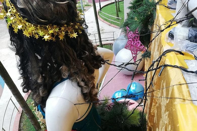 Christmas decorations with a mannequin as the centrepiece (above) on the second-storey ledge outside a flat at Block 351 Clementi Avenue 2. The mannequin appears to be fixed to the railing (below) using twine. Jurong-Clementi Town Council said the pi