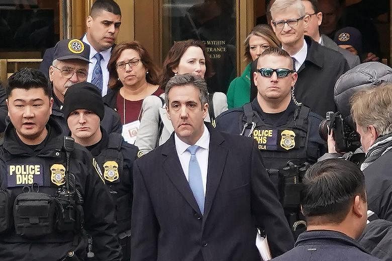 Michael Cohen leaving the Manhattan courtroom after his sentencing on Wednesday. He told the judge that "blind loyalty" led him to cover up for Mr Trump but he will now provide information on his former boss.