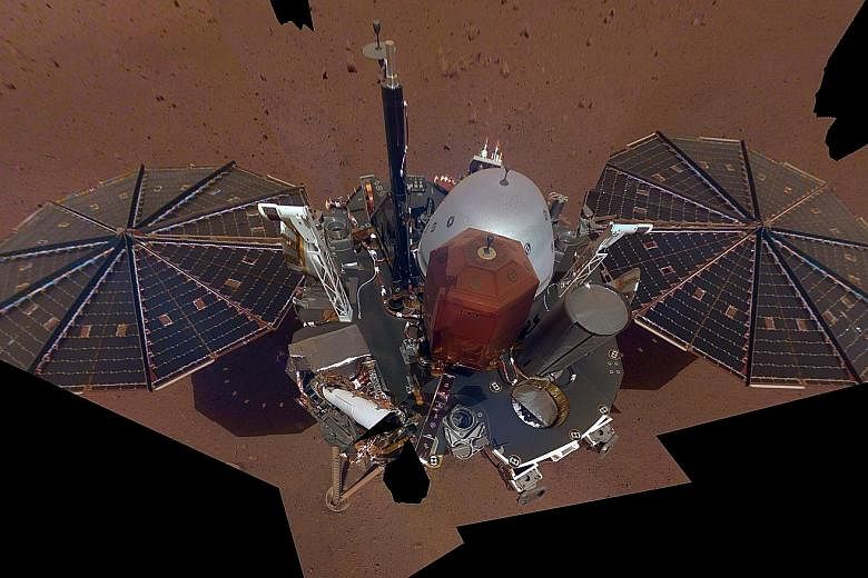 A photo from Nasa showing the first full selfie taken by its spacecraft InSight on Mars. It displays the lander's solar panels and deck. On top of the deck are its science instruments, weather sensor booms and antenna.