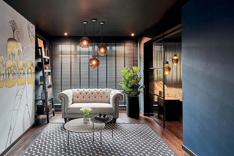 The positions of the day and night curtains have been swopped to give a sense of cosiness (above). A blue accent wall between the living room and kitchen (left) adds contrast to the mostly dark palette. The open-concept master ensuite is a combinatio