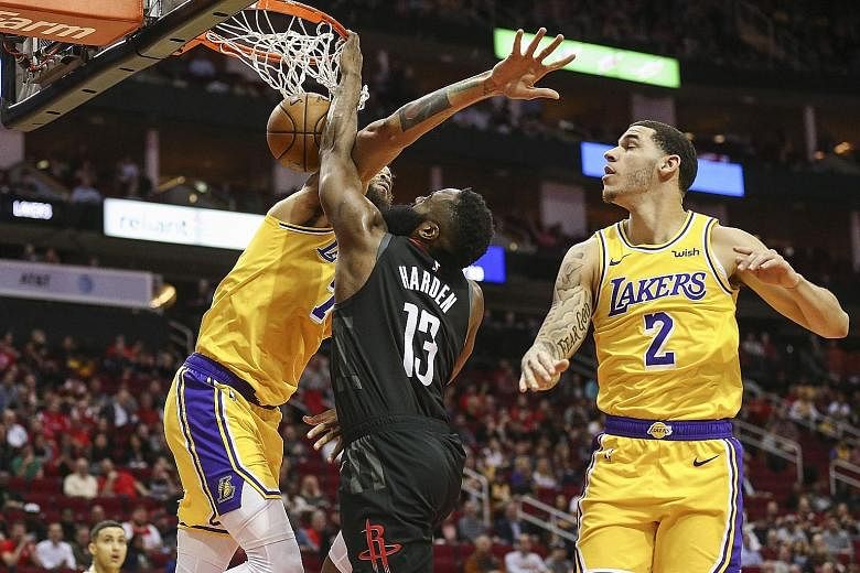 Rockets guard James Harden dunking over Lakers centre JaVale McGee in the first quarter of the game at the Toyota Centre in Houston, Texas. His reaction - he flexed both arms and snarled - had everyone taking notice. Houston won 126-111 but are still