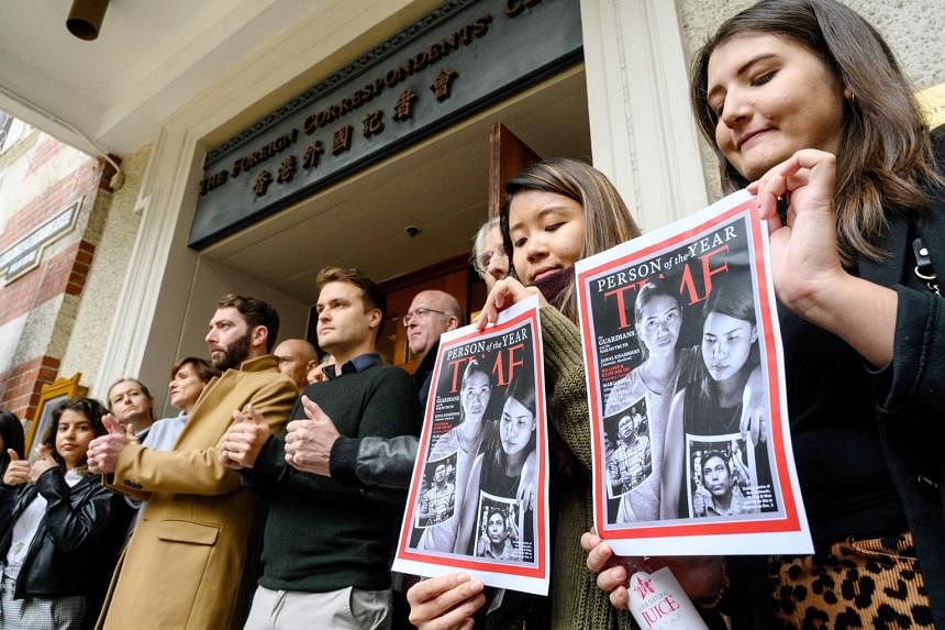 Supporters of jailed Myanmar journalists Wa Lone (bottom left of Time cover) and Kyaw Soe Oo (bottom right of cover) outside Hong Kong's Foreign Correspondents Club on Wednesday.