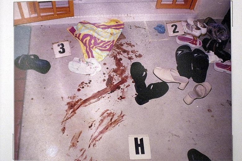 Above: Madam Annie Leong was stabbed multiple times outside the lift, seen in a photo taken last week, on the fourth floor of the Housing Board flat in Hougang on May 14, 2001. Below: The scene of the crime. Madam Leong died of her injuries in hospit