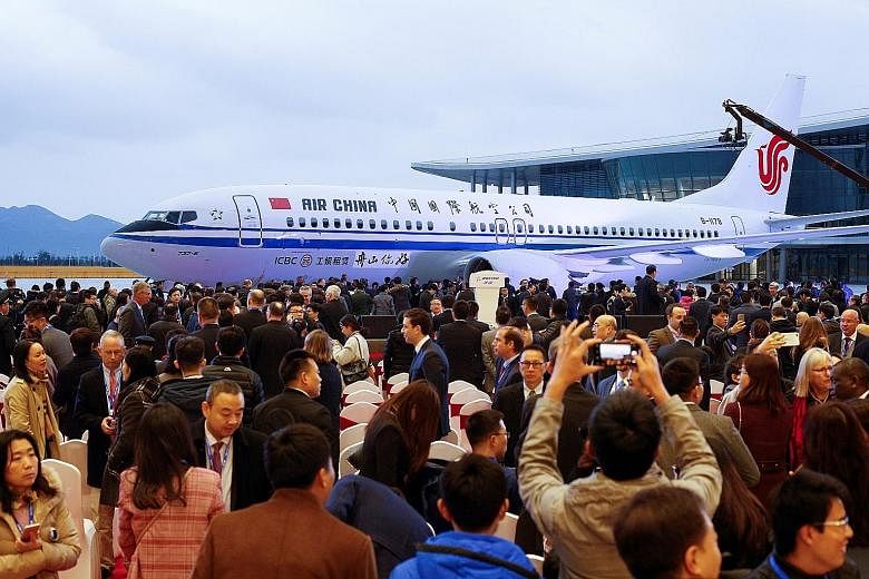 The ceremony marking the first delivery from Boeing's completion and delivery centre in Zhoushan, 145km south-east of Shanghai, last Saturday. Chinese workers at the completion centre, a joint venture between Boeing and state-owned Commercial Aircraf