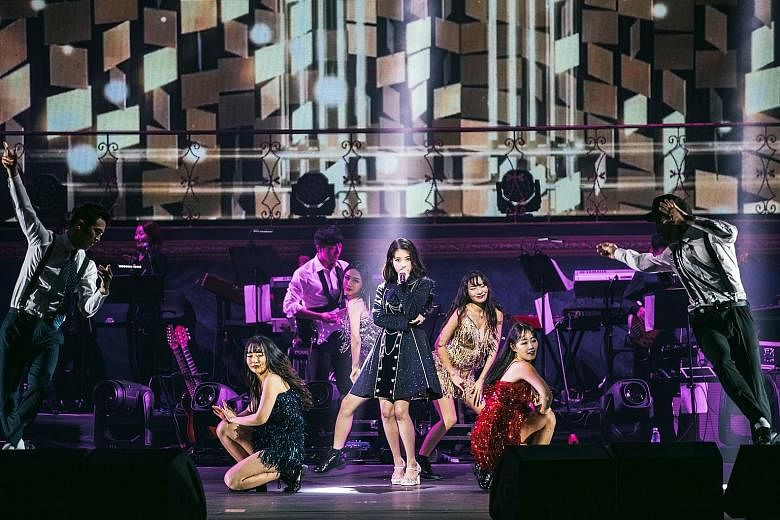 K-pop singer IU (centre) debuted at age 15 and her concert here, with a crew of back-up performers, was a review of her 10-year music career, during which she had won hearts with her cutesy image.
