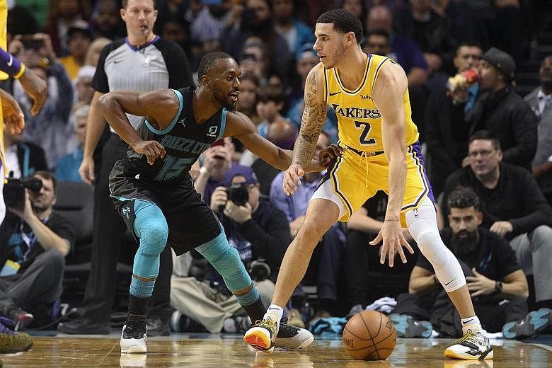 Lakers guard Lonzo Ball is defended by Hornets guard Kemba Walker at the Spectrum Centre in Charlotte. The Lakers won 128-100 for a seventh victory in nine games.