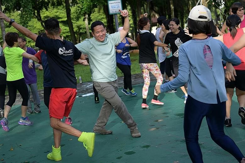 Senior Parliamentary Secretary for Health and Home Affairs Amrin Amin joining residents in a zumba session at Choa Chu Kang Park yesterday. He said the HealthySG Taskforce will work with community partners to guide low-income families in purchasing h