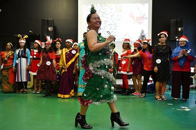 Filipino domestic worker Jane Hortillas Gabinete, 43, dressed up as a Christmas tree for a best-dressed competition during the festive celebration organised by the Foreign Domestic Worker Association for Social Support and Training yesterday at its c